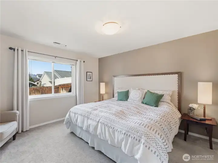 Main level primary bedroom with convenient layout and natural light