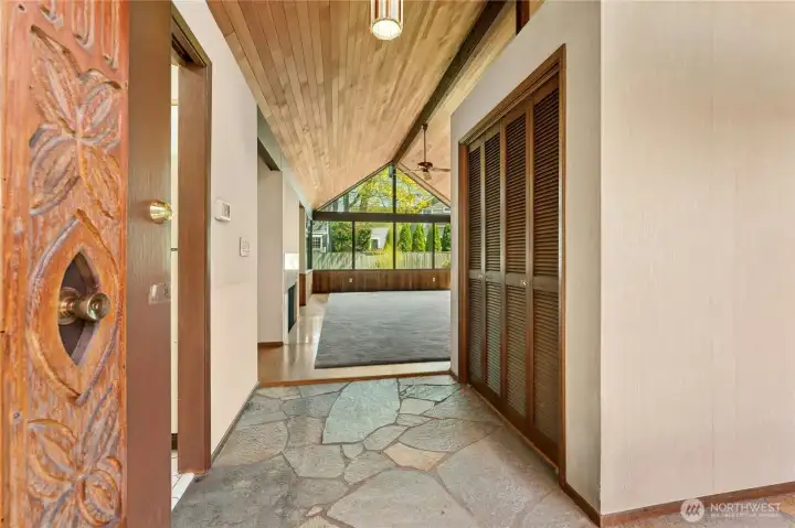 Slate stone entry. Custom carved front door