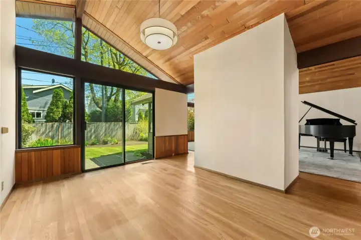 Vaulted ceilings and oak hardwood floors in the dining room.