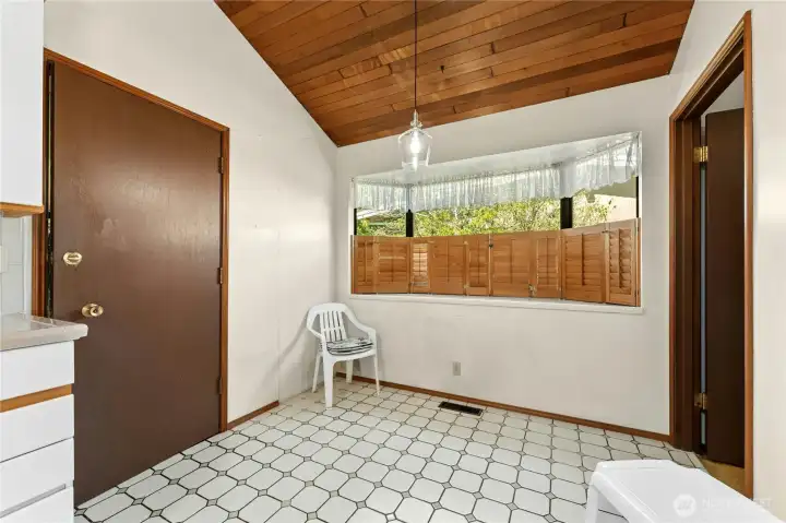 Kitchen has a casual dining space.  Door leads to the pantry and garage.