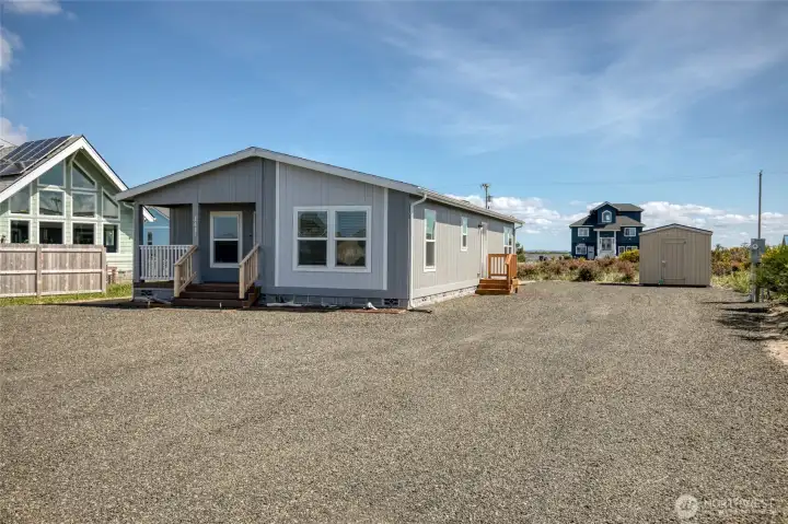 Brand new home with ample parking, RV hookups, and an EV charging station.