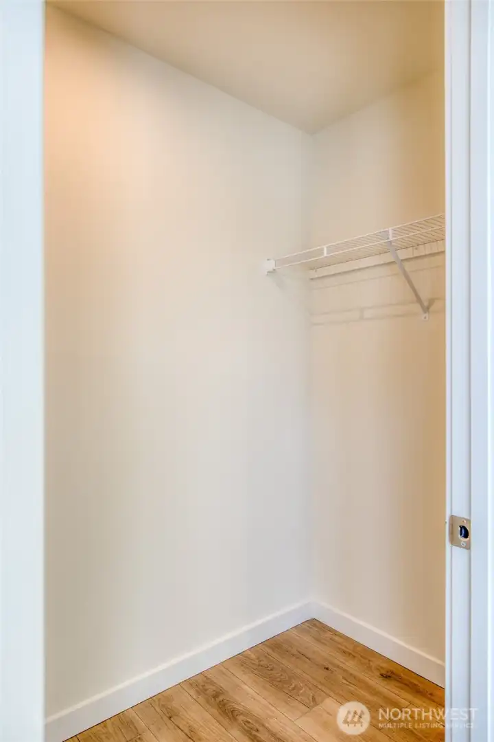 Walk in closet in primary suite.