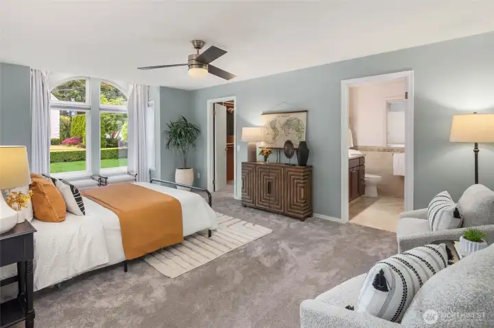 Luxurious primary suite with updated bathroom and spacious closet.