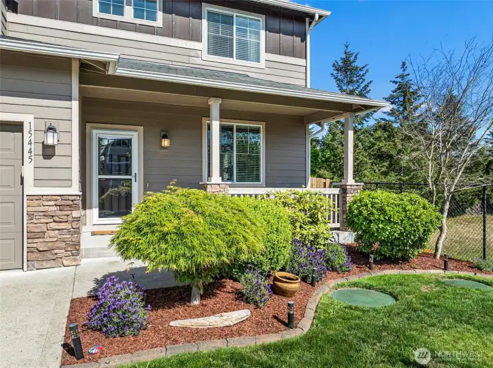 Beautifully landscaped front yard and covered front porch.