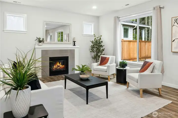 The gas fireplace adds lovely ambiance to the spacious living room. The gas fireplace adds lovely ambiance to the spacious living room.