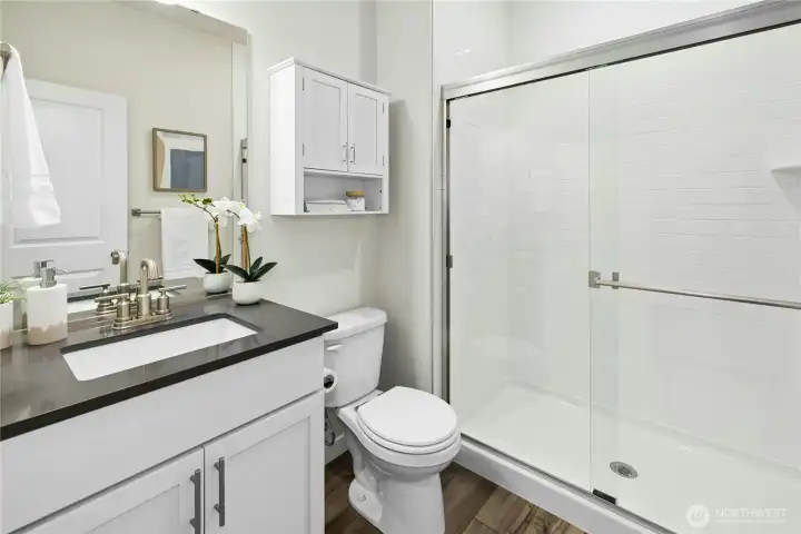 The main floor guest bath is adjacent to the guest bedroom. The main floor guest bath is adjacent to the guest bedroom.
