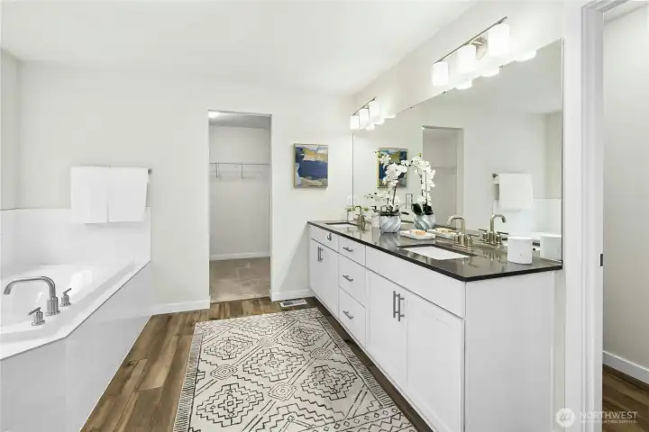 The ensuite primary bath boasts gorgeous finishes, a double sink vanity, separate shower and soaking tub. The huge walk-in closet is just through the doorway. The ensuite primary bath boasts gorgeous finishes, a double sink vanity, separate shower and soaking tub. The huge walk-in closet is just through the doorway.