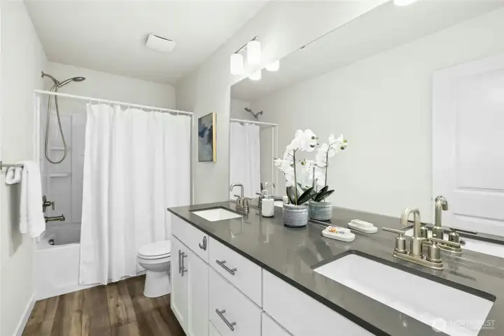 The guest bath has quartz counters and a full tub/shower combo. The guest bath has quartz counters and a full tub/shower combo.