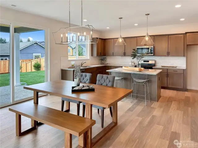 8ft sliding glass door, 6'0x6'0 windows lets in natural light.  Single basin undermount stainless steel sink overlooks wooded backyard - very private.  *Photos not of actual home - same floor plan in a different community*