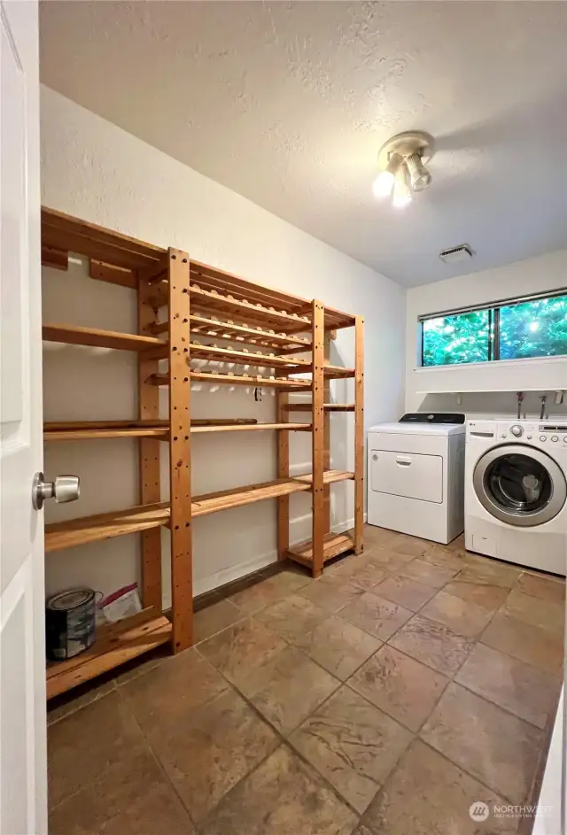 The utility room inside the unit is very large and includes shelving.