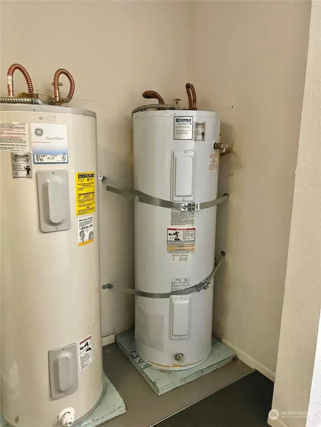 The water heater is located by the stairwell in the common area that leads to the storage units.