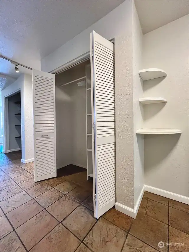 Sizable entryway features a large coat closet & shelves that serve as a catchall for mail, keys, etc.