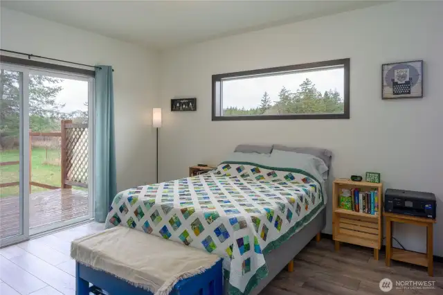 Guesthouse bedroom looking out toward back deck and firepit