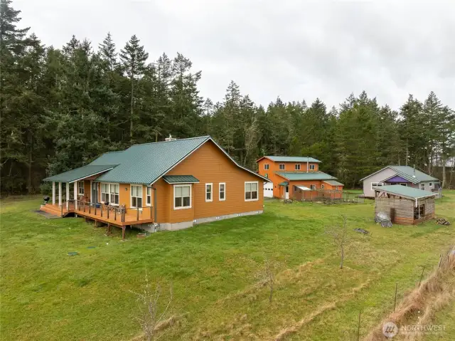 Main house on left, barn in middle, guest house and woodshed on right