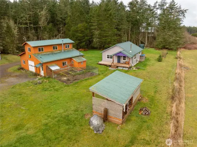 Barn on left, guesthouse on right, woodshed in foreground