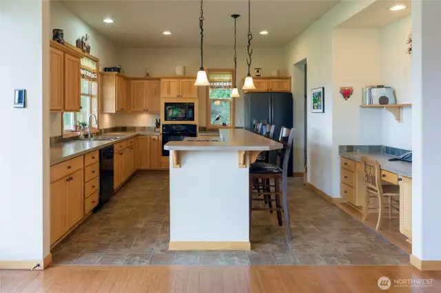 Kitchen with desk area to right, windows with territorial view on left