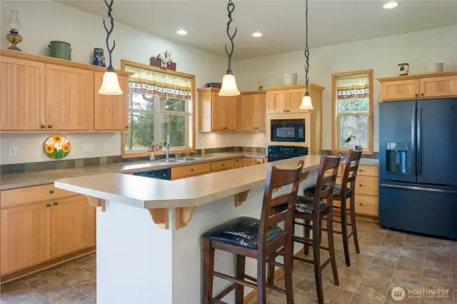 Kitchen with island seating, ample storage, Jenn-Air range