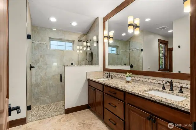 Heated floor and beautiful walk-in shower in primary bathroom.