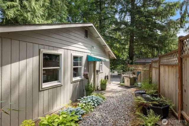 Side yard for Studio B, the detatched Studio that has a monthly rental income of $1650/month! The current tenant is WONDERFUL and would love to stay!