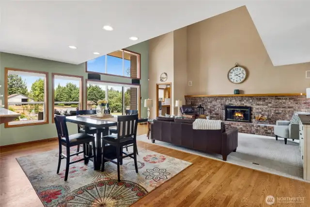 Dining space in kitchen adjacent to living room with oak hardwood floors.