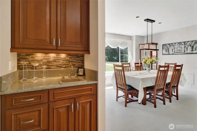 Formal dining area with wet bar and bar fridge.