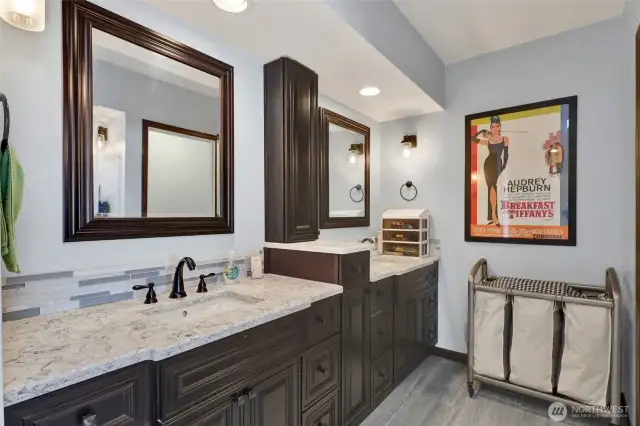 Primary bathroom with dual vanities.