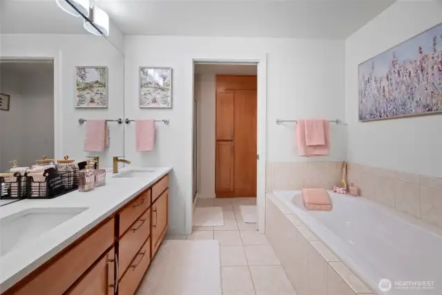 Primary Bath featuring double vanities and large soaking tub. Shower and toilet are just through the door in the background.