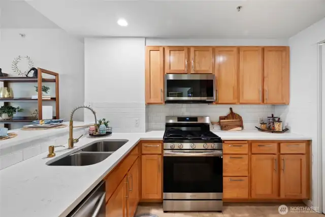 Gorgeous kitchen with new quartz countertops and subway tile backsplash.
