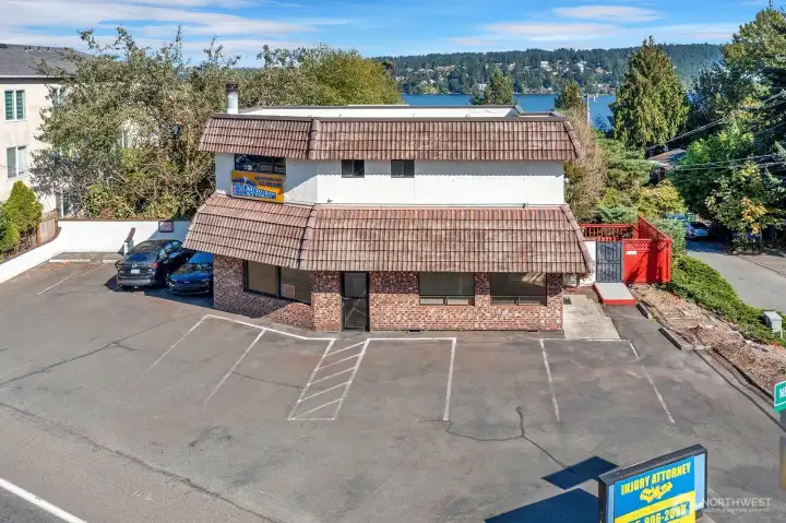 Office space below with 1/2 bath. 2-bed/1-bath above. 9 parking spaces!