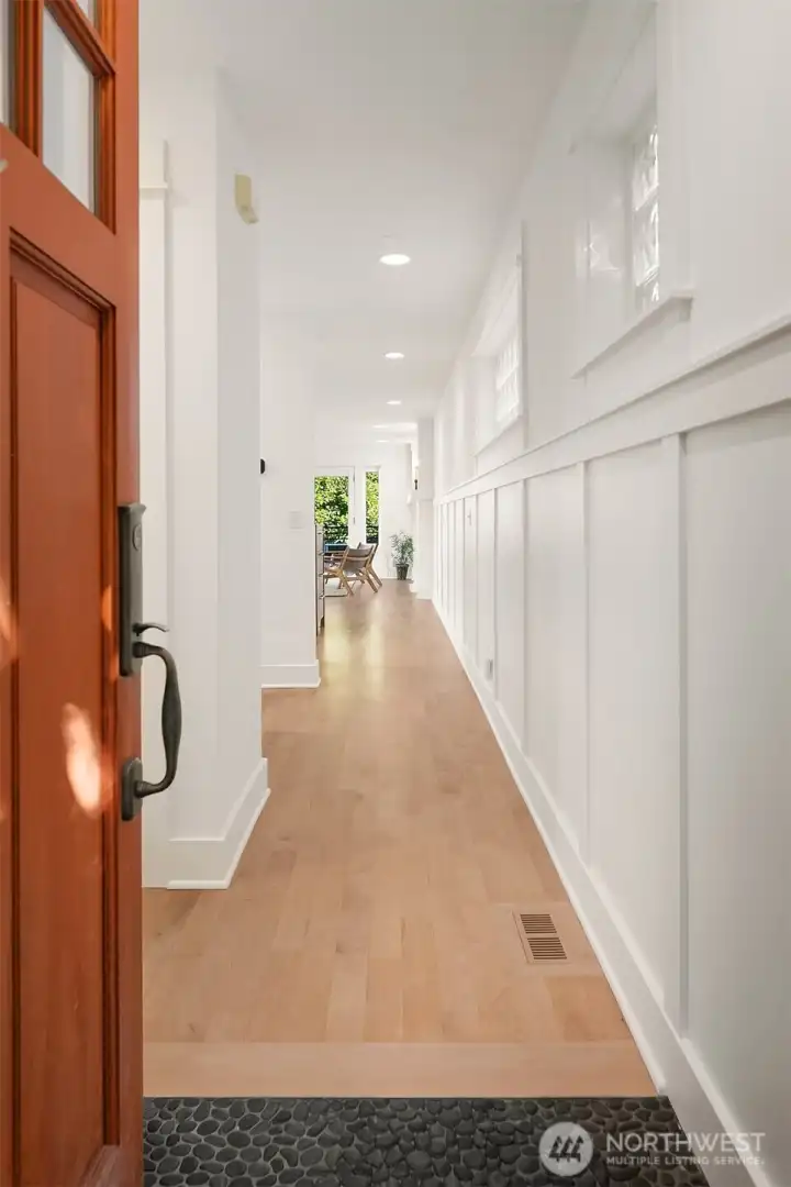 Entry with pebble floor leading to Maple hardwood floors.