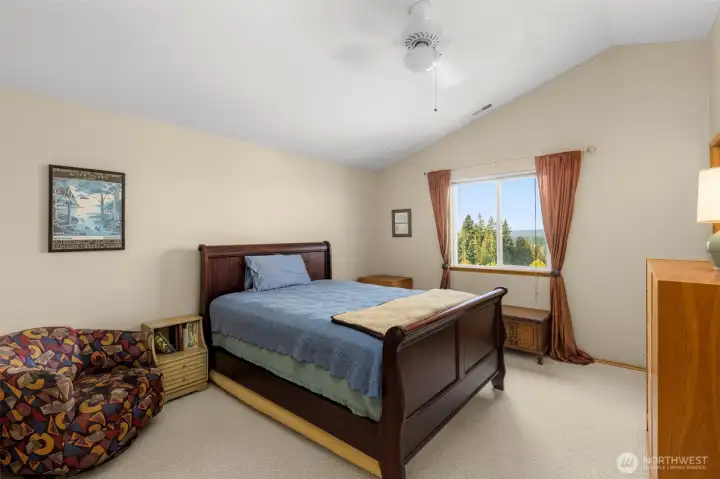 Spacious primary bedroom with en suite bath, ceiling fan, and of course, the views!
