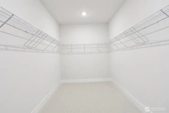 An oversized primary walk-in closet provides endless storage possibilities.