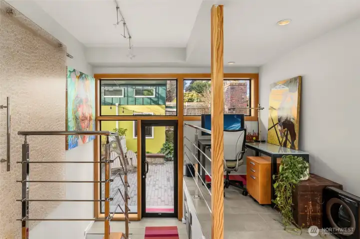 Large wall of windows connects the indoors & outdoors - making a cozy spot to get work done at home