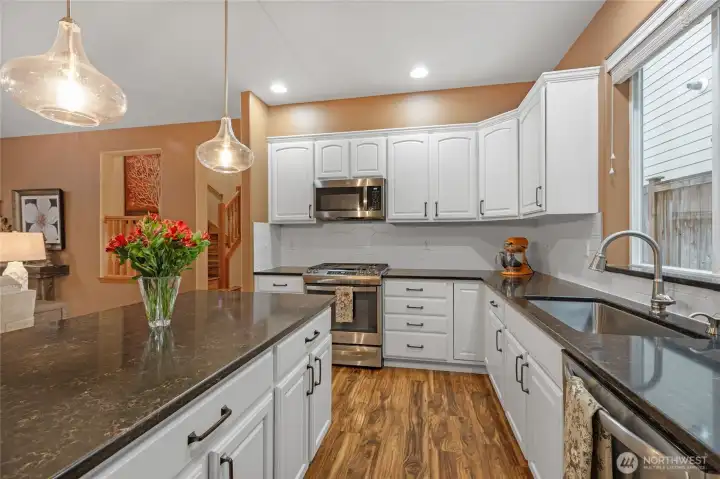Thoughtfully designed for the home chef, this kitchen features ample cabinet storage, a deep under-mount sink, and a layout that keeps everything within reach while overlooking the living areas.