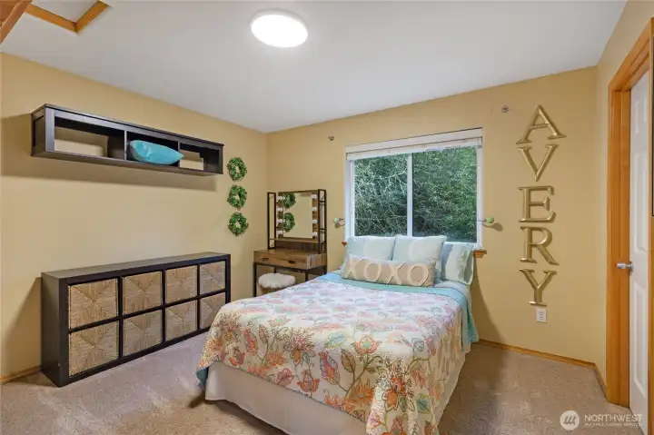 Generous in scale, the third upstairs bedroom offers a cozy yet airy retreat. The large closet and ample wall space allow for flexible furniture arrangements, while the abundance of natural light enhances the room's warm and welcoming atmosphere.