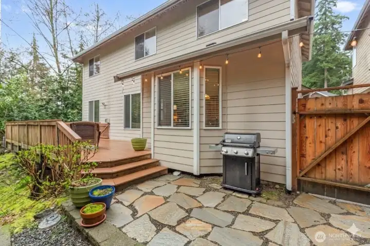 Experience ultimate tranquility in your private backyard sanctuary. The expansive deck and flagstone patio are perfectly positioned to enjoy the peace of the unbuildable greenbelt to the East.