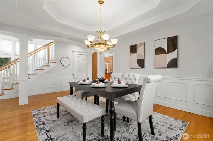 Formal dining room framed by architectural columns and elevated millwork. Double coved ceilings.