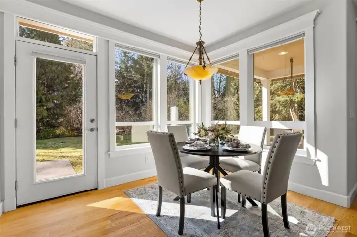Light-filled eating area in the kitchen leading to the back patio.