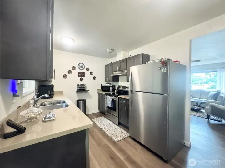 Beautiful kitchen with great appliances with elegant luxury vinyl plank flooring.
