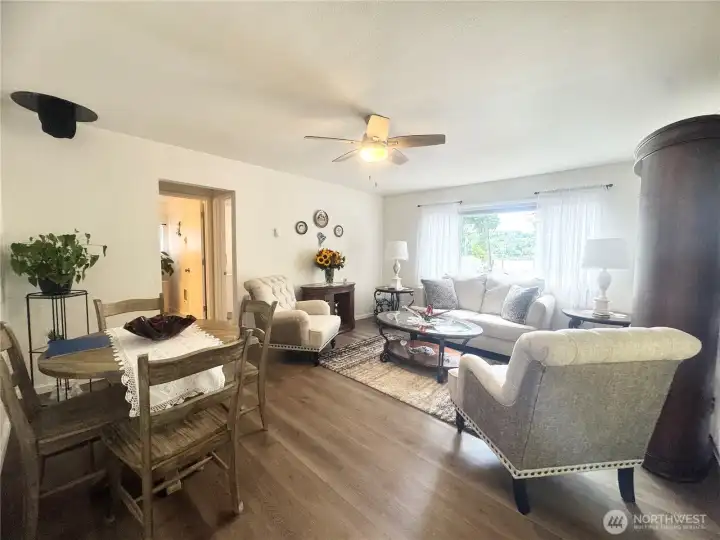 Living room offers lots of space and Luxury Vinyl Plank flooring. The open concept design creates a bright and inviting atmosphere, perfect for relaxation and entertainment.