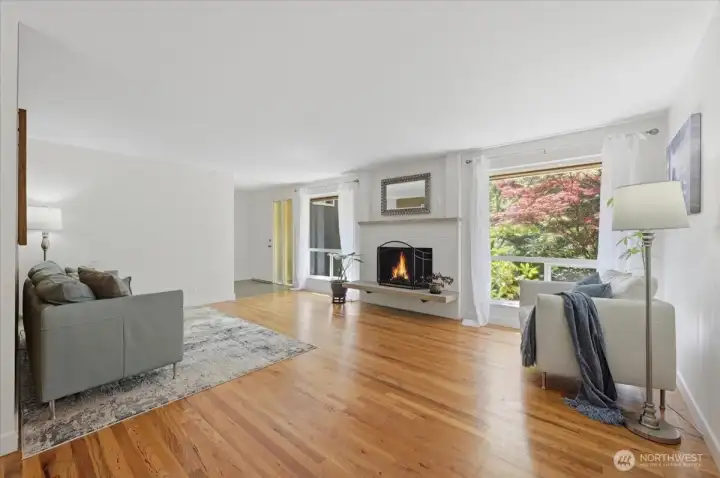 Oak hardwood floors, large picture window, wood burning fireplace create a warm and inviting space.
