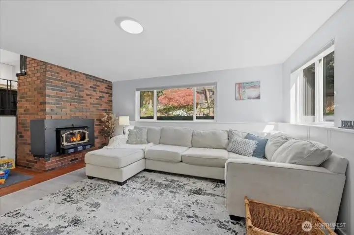 Family room with woodburning fireplace is great for movie night or hobbies.