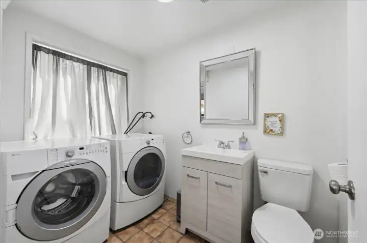 Laundry room with half bath in adjacent to the family room.