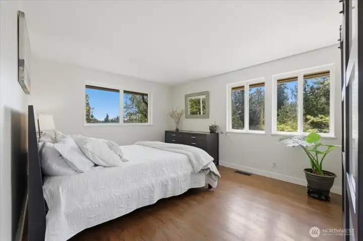 Territorial views from the walls of windows in the primary bedroom provide a peaceful retreat.