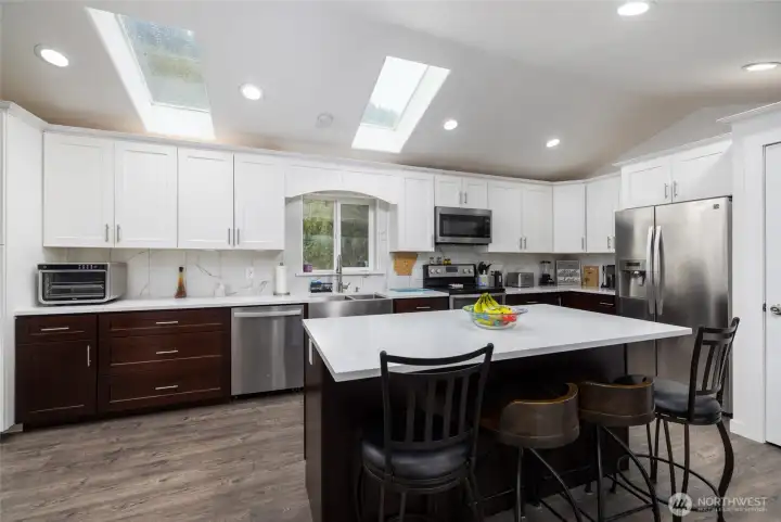 Large open kitchen with stainless appliances & lots of storage. Large open kitchen with stainless appliances & lots of storage.