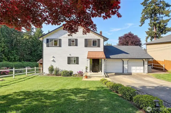 Inviting curb appeal with mature landscaping.