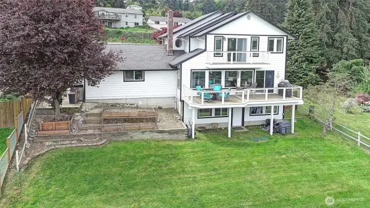 Large entertaining deck overlooking the fenced yard with room for your garden.