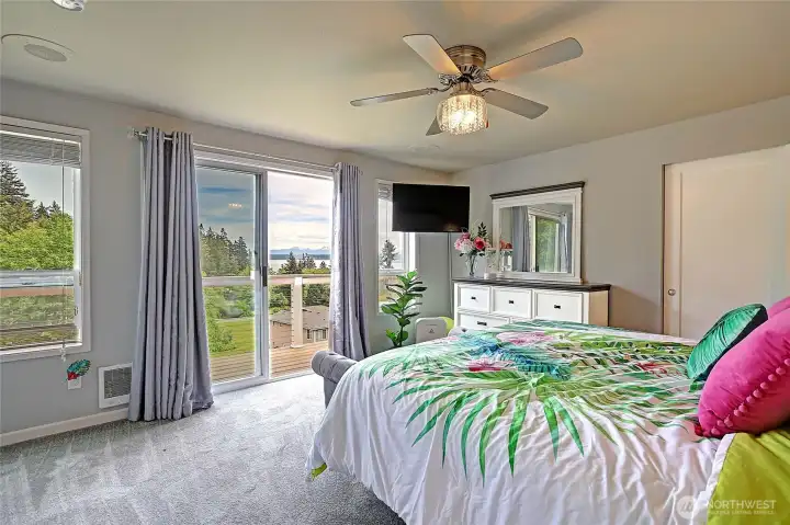 Spacious primary bedroom with private deck access.