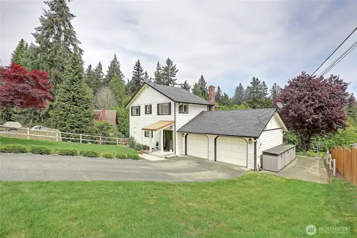 Large garage with built-in storage and additional exterior storage space.