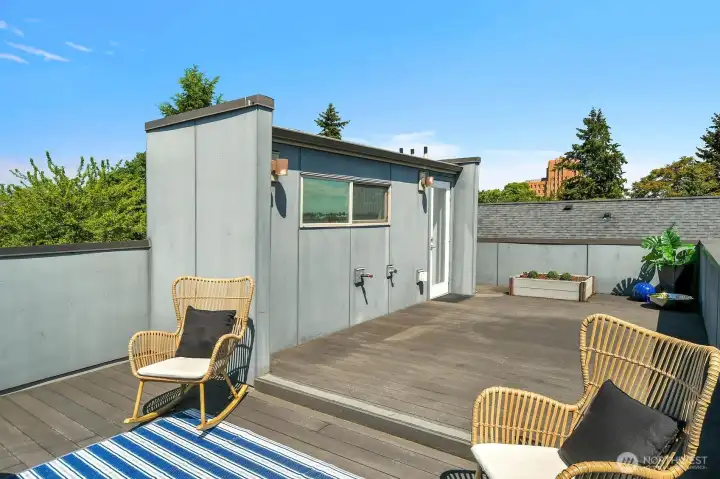 Sunny Rooftop deck surrounded by sky with room for seating, gardening, dining & enjoying the view. The seller liked to hold yoga gatherings up here.